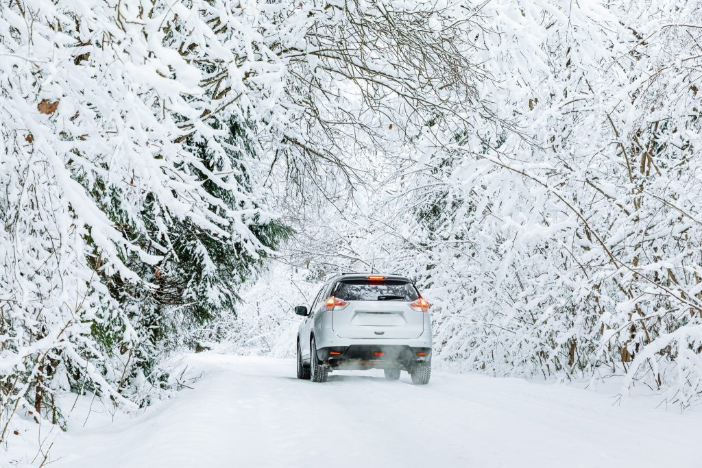 car-on-a-winter-road-in-snow-covered-forest-2022-01-24-18-31-50-utc-scaled